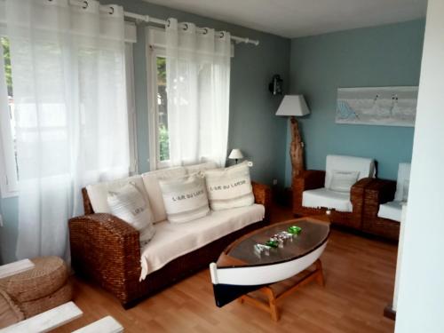 a living room with a couch and a coffee table at gite a st germain sur ay in Bretteville-sur-Ay