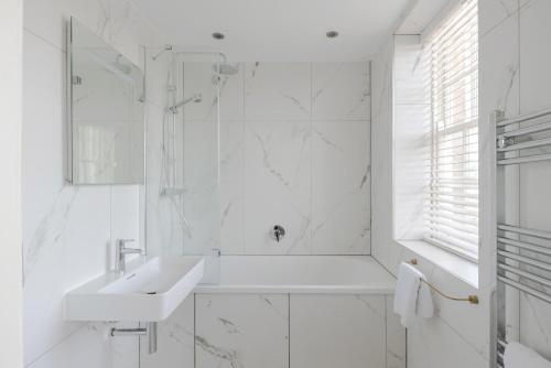 a white bathroom with a sink and a shower at Redcliffe Parade No 9 I City Centre in Bristol