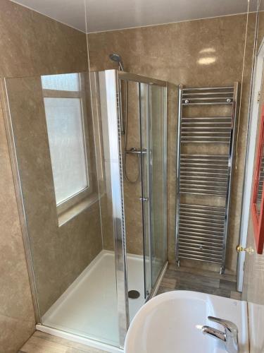 a bathroom with a shower with a sink and a shower at Aegir House in Gainsborough