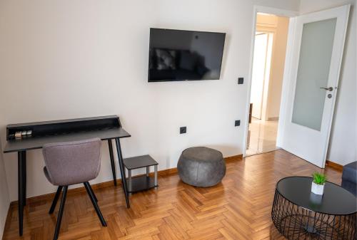 a living room with a piano and a table at CENTRAL ROOF NK CHANIA in Chania