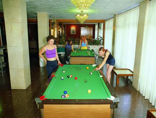a group of people standing around a pool table at HOTEL CONTINENTAL in Calella