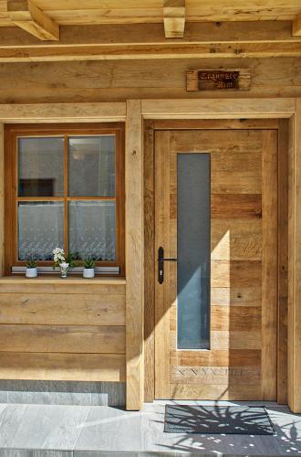 a wooden building with a door and two windows at Keramikhaus Gmunden in Gmunden