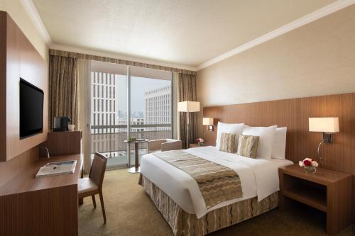 a hotel room with a large bed and a large window at Treffen House Doha - Souq Waqif and next to Msheireb Metro Station in Doha