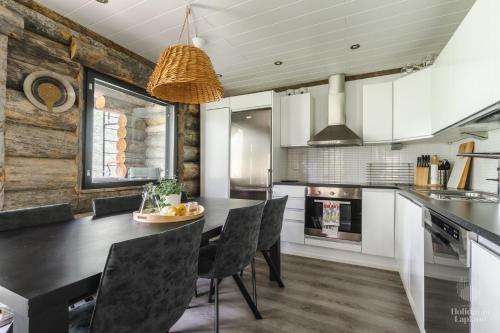 a kitchen with a dining room table and chairs at Holiday In Lapland - Riekkopolku 2 B in Levi