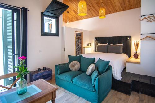 a living room with a bed and a couch at Welcôm Apparts-chic et intimiste-100m du Port in La Teste-de-Buch