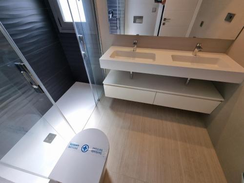 a bathroom with a sink and a mirror at Sidi Luxury (Beach & Golf) in Alicante
