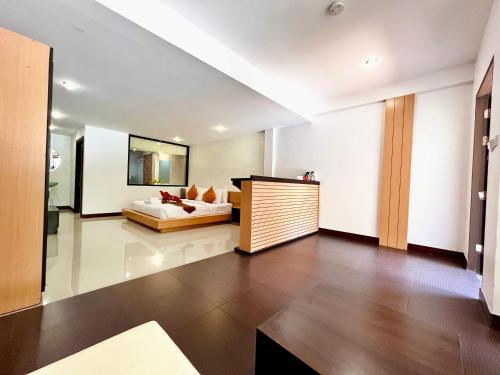 a large living room with a bed and a couch at Hotel La Villa Khon Kaen in Khon Kaen