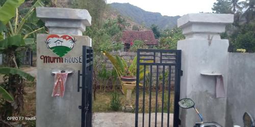 a iron gate with a sign that says yawn house at Murni house in Ambat