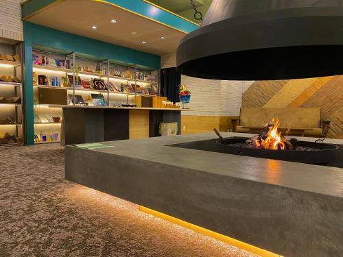 a fire pit in the middle of a room at Hotel Edel Warme in Furano