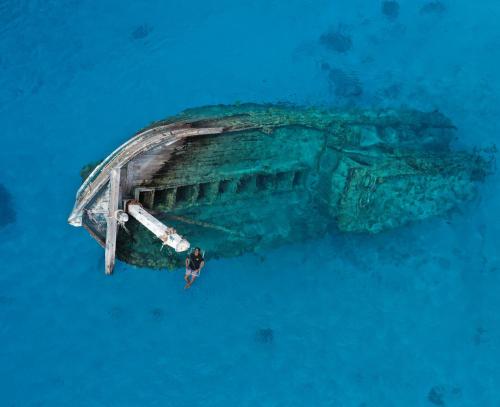 a person swimming on a boat in the ocean at The Pearl Seaview in Fulidhoo