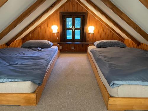 two beds in a room with a attic at Mountain Heart House in Bosanski Petrovac