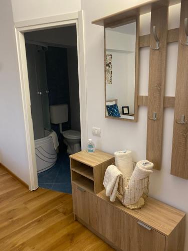 a bathroom with a vanity with a mirror and a toilet at Vila Hestia in Constanţa