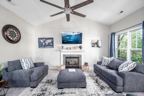a living room with two couches and a fireplace at Cozy Industrial Kildaire Farms Home- near Downtown in Cary