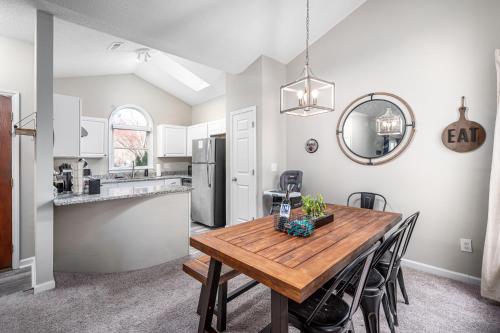 a kitchen and dining room with a wooden table at Cozy Industrial Kildaire Farms Home- near Downtown in Cary