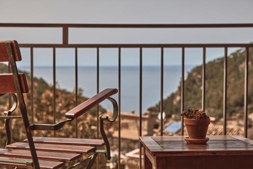 a bench and a plant on a table on a balcony at Maristel Hotel & Spa - Adults Only in Estellencs