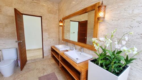 a bathroom with a sink and a mirror at Diamond Villa in Laem Sor