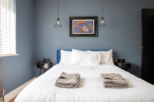 a bedroom with a white bed with towels on it at Withnell Stays - Apartment Five in Blackpool