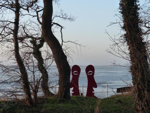 a pair of black shoes standing next to a tree at Strand-Hotel in Dangast