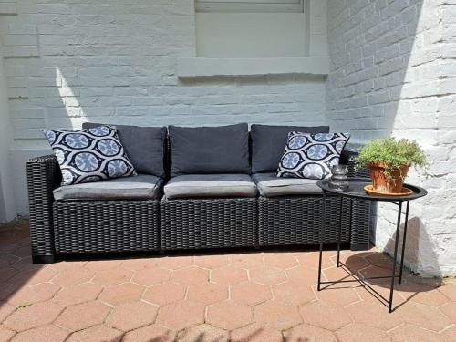a black couch sitting on a patio with a table at Waldstadt-Apartments in Iserlohn