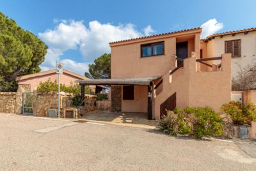 a house with a driveway in front of it at Erica Piano Terra & Erica Primo Piano in Golfo Aranci