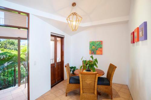 a dining room with a table and chairs at L'Auberge Noosa in Noosa Heads
