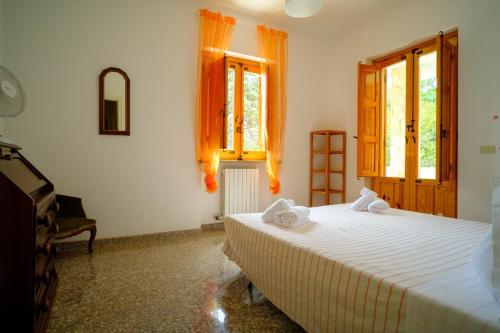 a bedroom with a bed with towels on it at Dimore Tarantini in Polignano a Mare