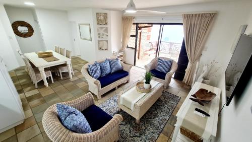 a living room with couches and a table and a dining room at Annie Benn 5 in Mossel Bay