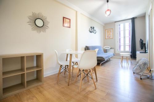 a living room with a table and chairs and a couch at Cœur historique classé in Périgueux