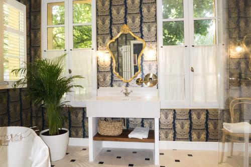 La salle de bains est pourvue d'un lavabo et d'un miroir. dans l'établissement Villa Amara, à Aix-en-Provence