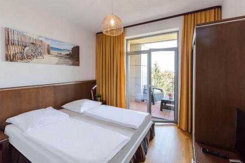 Posteľ alebo postele v izbe v ubytovaní VacationClub - Diune Apartment 63