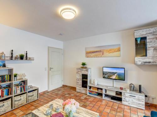 a living room with a tv and a fireplace at FeWo Tusculum in Zinnowitz