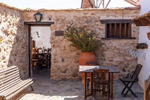 a restaurant with tables and chairs and a vase with flowers at Casa Rural Tamasite in Tuineje