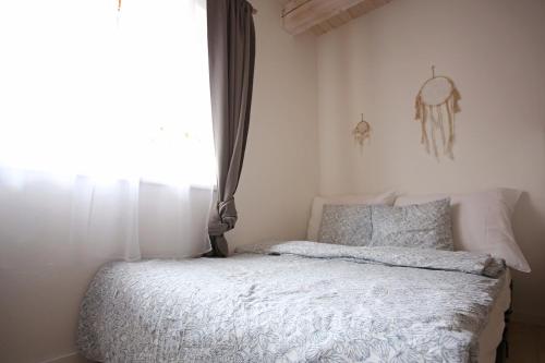 a bed in a bedroom with a window at Husovka No135 in Libice nad Cidlinou