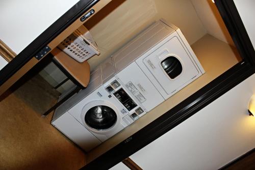 a microwave sitting on top of a counter with a telephone at Capri Inn & Suites - Beatrice in Beatrice
