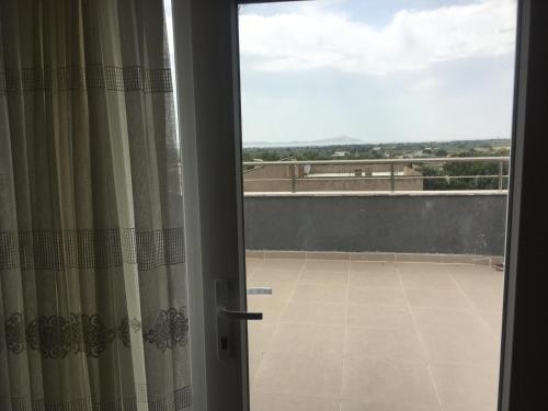 a sliding glass door with a view of a balcony at Geyikli Lotus Apart in Canakkale