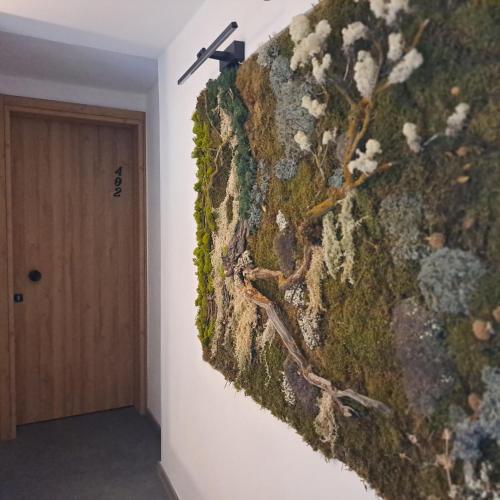 a wall in a room with a moss covered wall at Nisaki Hotel & Elite Suites in Ermoupoli