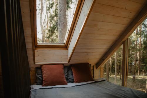 A bed or beds in a room at Private cosy forest cabin