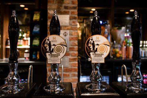 two bottles of beer on display in a bar at The Northallerton Inn - The Inn Collection Group in Northallerton