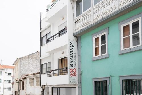 a building with a sign on the side of it at Bragança Apartments in Bragança
