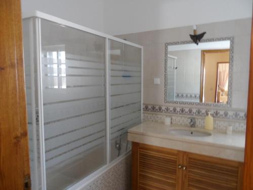 a bathroom with a shower and a sink and a mirror at Hedone Sintra in Sintra