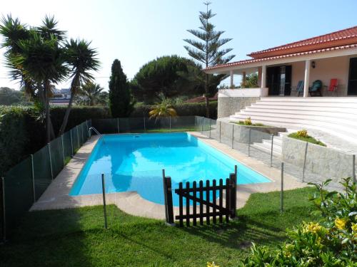 a swimming pool in a yard next to a house at Hedone Sintra in Sintra