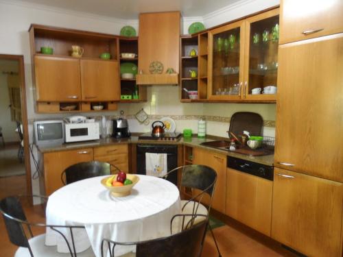 a kitchen with a table with a bowl of fruit on it at Hedone Sintra in Sintra