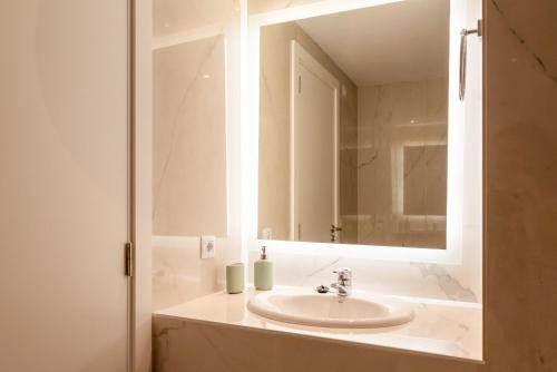 a bathroom with a sink and a mirror at Bellamar Apartments in Port d'Alcudia