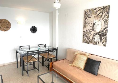a living room with a couch and a table at Apartamentos Ulia in Benidorm