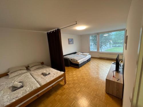a room with two beds and a window at House Marin II - Apartment in Maribor