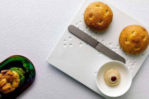 a cutting board with a knife and some food on it at Principe Forte Dei Marmi - Resort & Spa in Forte dei Marmi