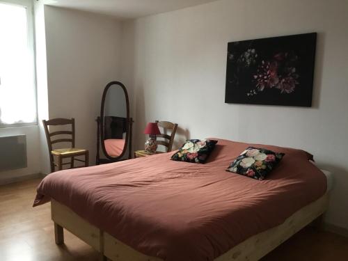um quarto com uma cama com duas almofadas em Maison de centre ville 6 personnes em Précigné