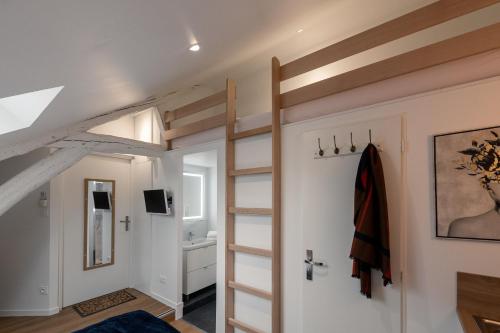 a room with a loft bed and a bathroom at Les Clés de La porte Saint-Nicolas - Parking - Centre in Beaune