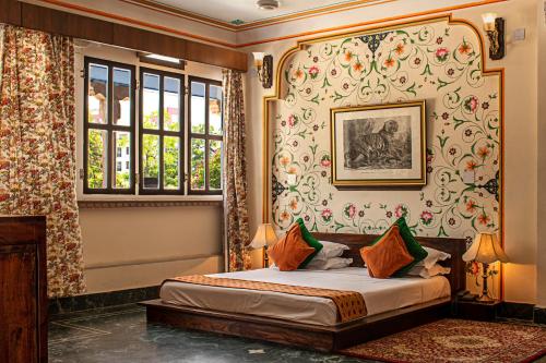 a bedroom with a bed and a window at Diggi Palace A Luxury Heritage Hotel in Jaipur