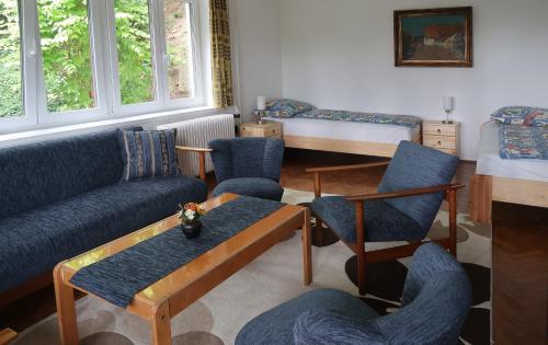 a living room with a couch and chairs and a bed at Váralja Vendégház Tihany in Tihany